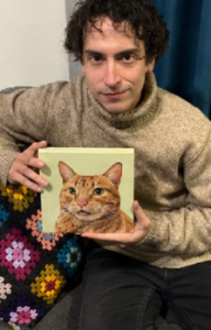 Hombre joven con el cuadro de su mascota gato